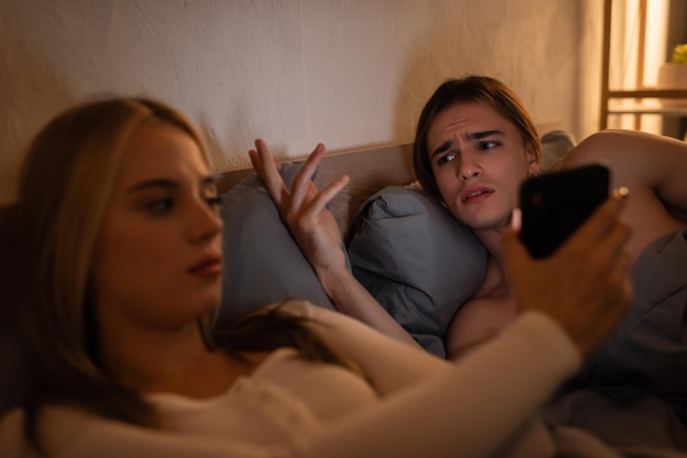An Angry partner confronted with a smartphone, symbolizing suspicion, infidelity, and the emotional impact of betrayal.