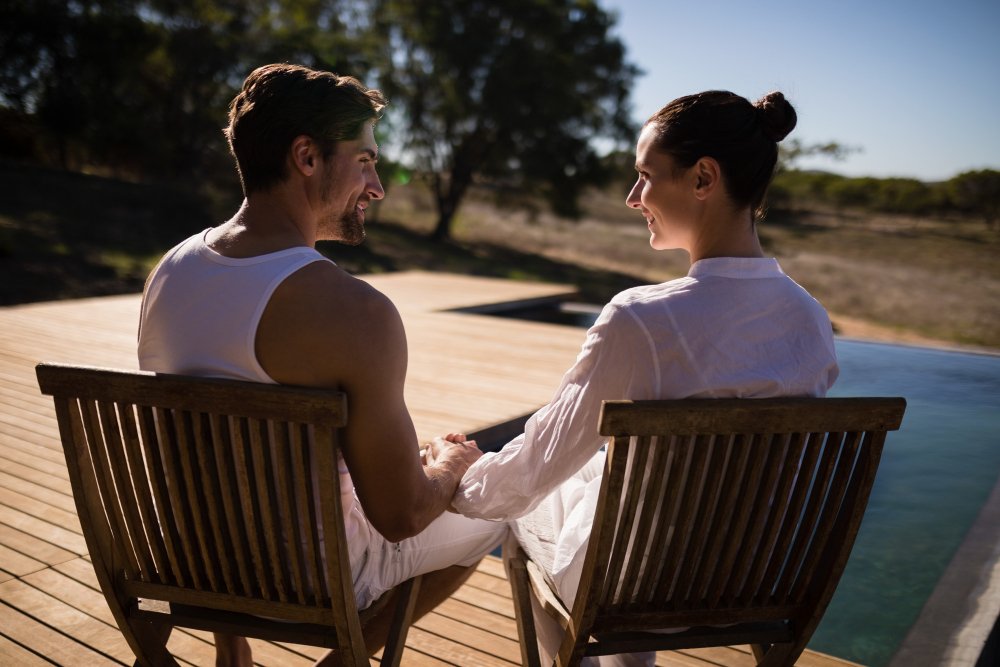 Couple relaxing together in a chair during a romantic safari vacation retreat.