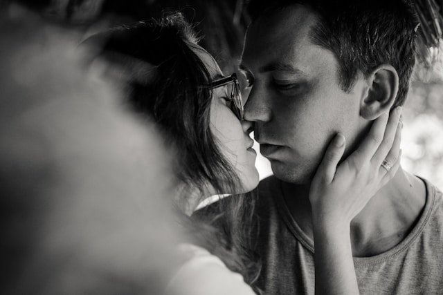 A couple sharing a kiss, representing the renewed intimacy that a well-structured and private marriage weekend retreat builds 
