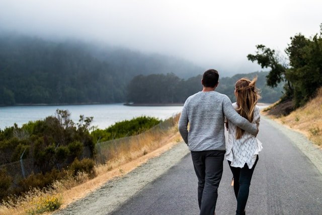 A couple on an open road, representing the forward momentum that sustained betrayal trauma therapy work can achieve over time 
