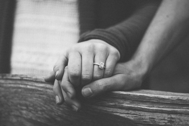 Joined hands with a wedding ring visible, representing the commitment couples hold at the heart of infidelity trauma recovery 