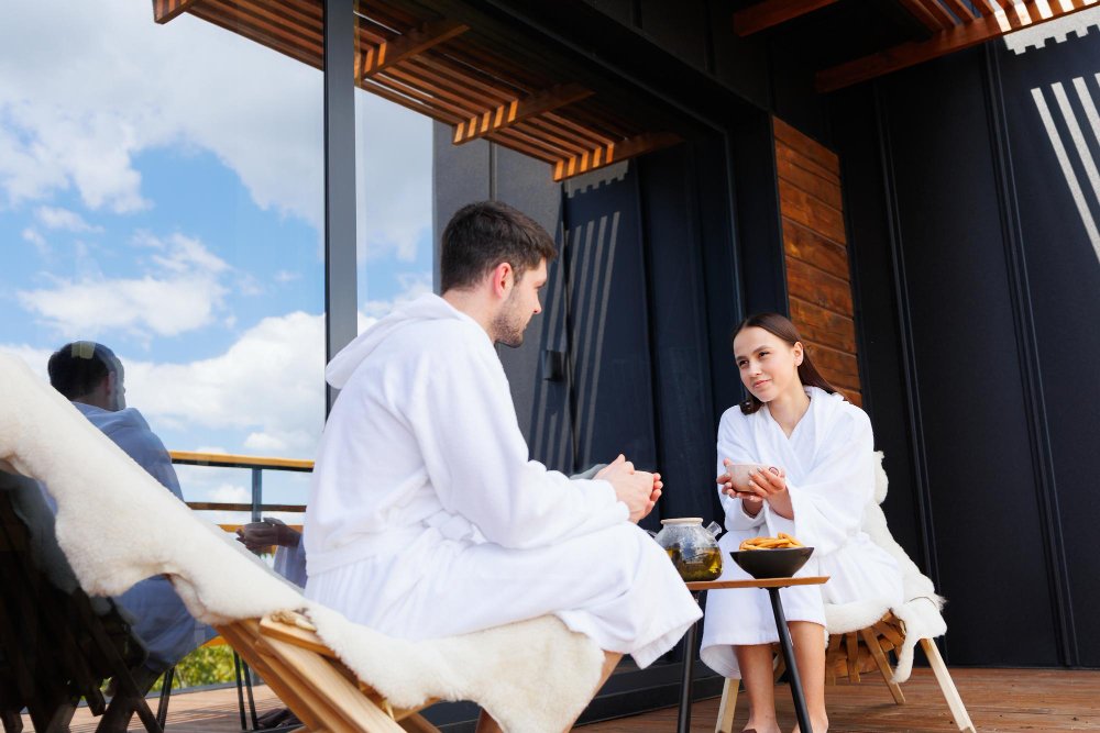 A couple sharing tea on a shaded patio, a cozy stop on a couples retreat itinerary.